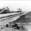 The St. Lucie Canal continues to grow in this picture which shows dredge pilings on the banks of the newly cut canal.